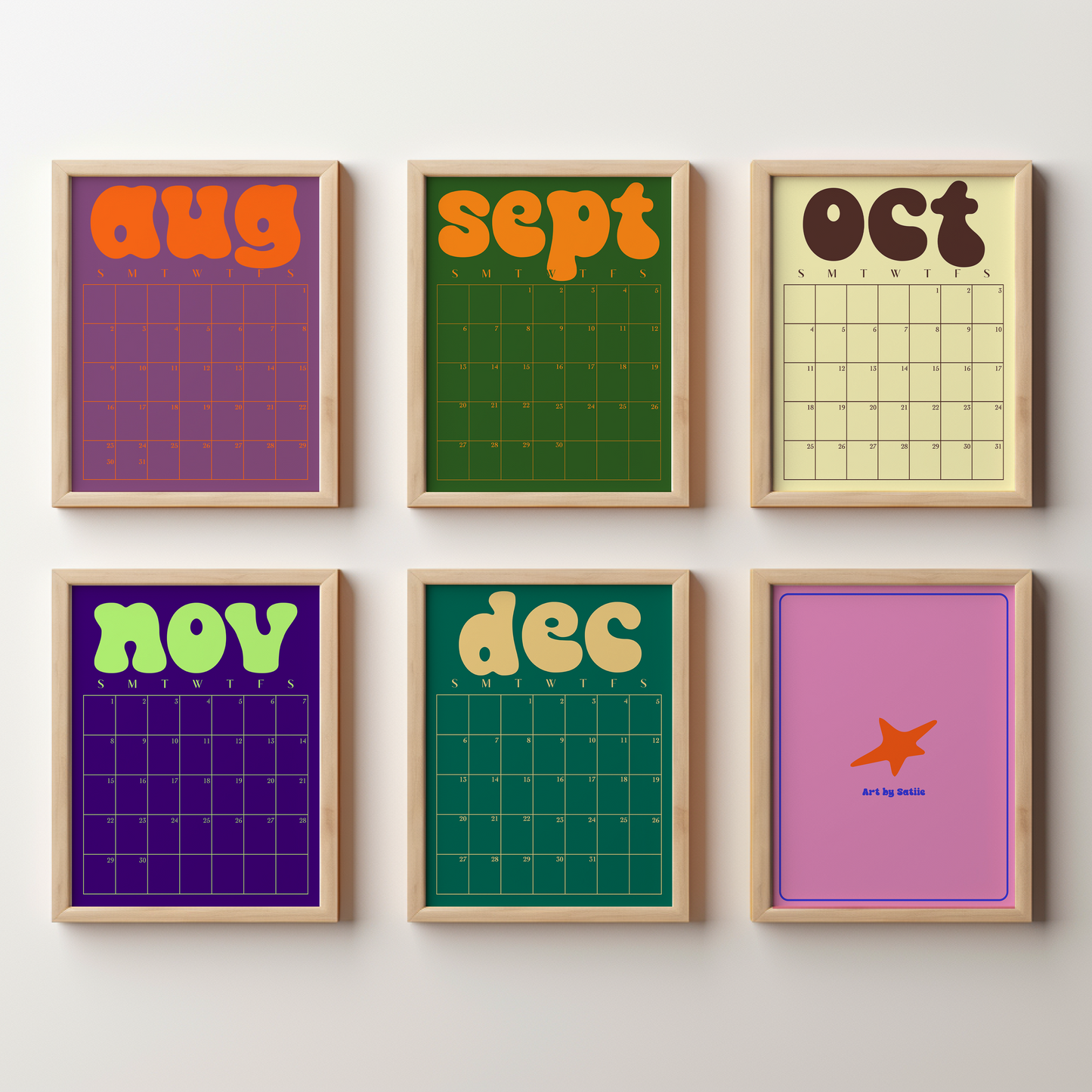 Six framed monthly calendar prints arranged in a 2x3 grid on a light wall. The prints feature retro 1970s-style designs with bold retro text for each month (aug, sept, oct, nov, dec, and an airplane graphic for december) in various vibrant colors on purple, green, yellow, and pink backgrounds, all enclosed in light wood frames.